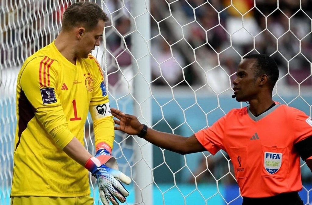 Referee checks Germany captain Manuel Neuer's armband if it adheres to FIFA's rules