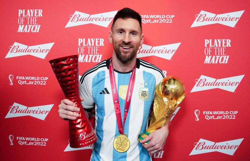 Messi picks up the player of the match award along with the World Cup trophy