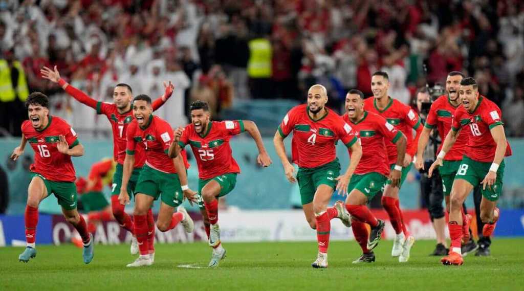 Morocco celebrate Hakimi's winning panenka penalty against Spain in the 2022 World Cup